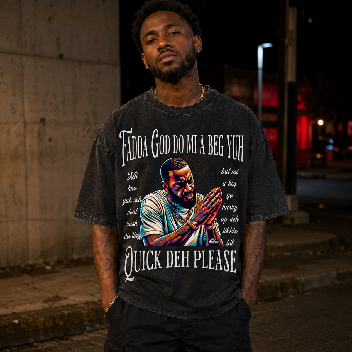 Male model wearing black Fadda God Mi a Beg Yuh oversized T-shirt