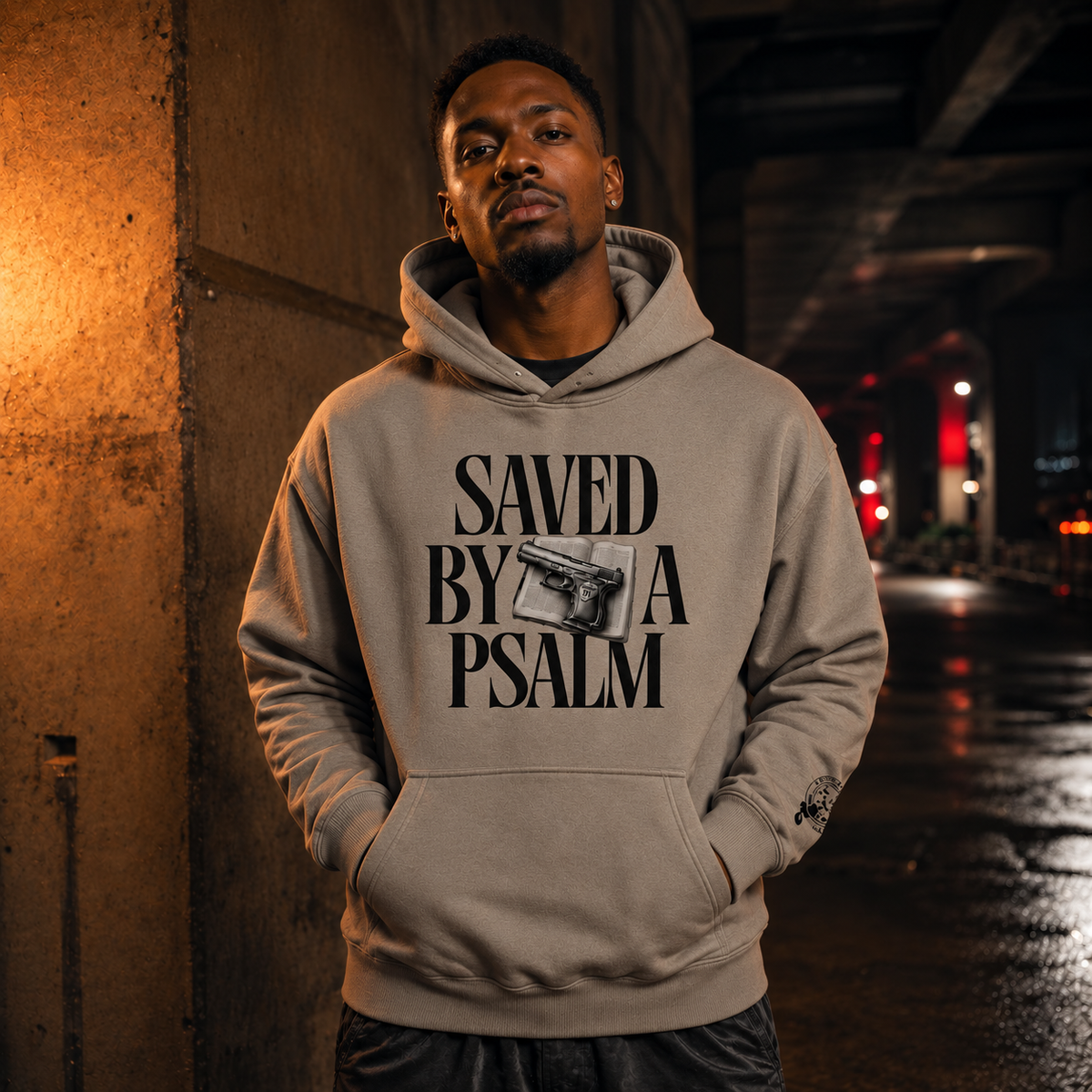 Male model wearing Saved By A Psalm Gray Apricot hoodie — front view