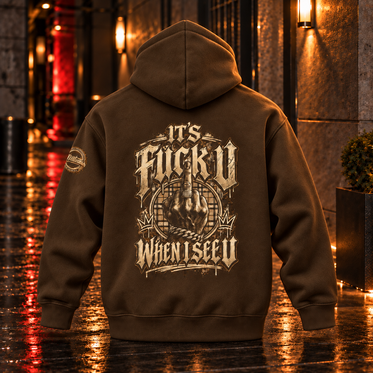 Back view of the Coffee Anyweather FUCK U WHEN I SEE U oversized fleece hoodie in a wet nighttime corridor