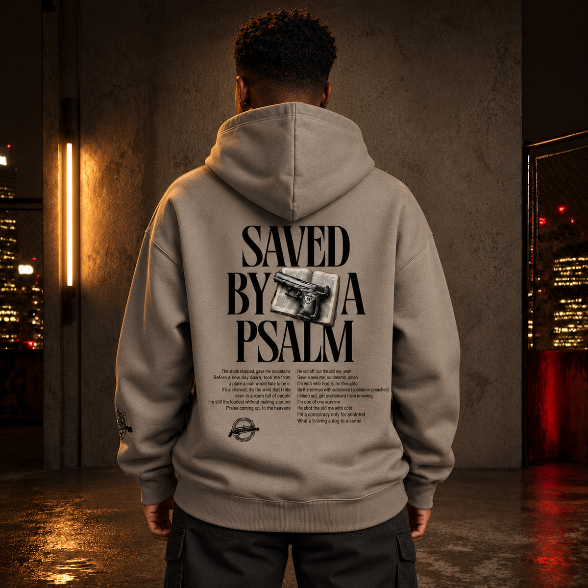 Male model wearing Saved By A Psalm Gray Apricot hoodie — back view